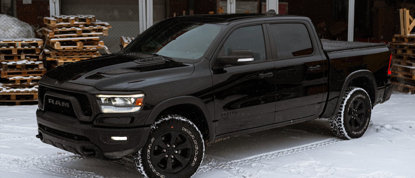 Black 4x4 pickup truck on snow